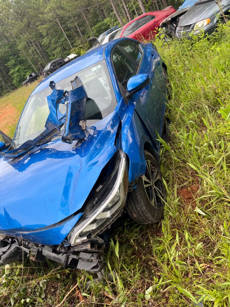 Blue car with heavy front-end accident damage