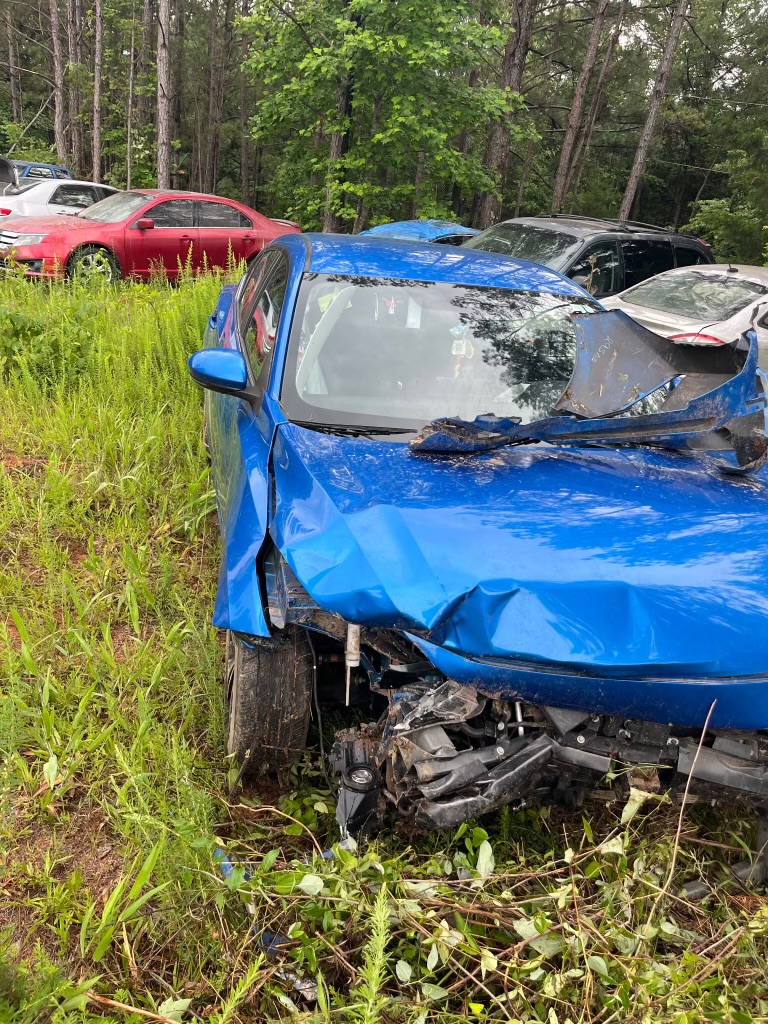 Blue car with damage shown from front side